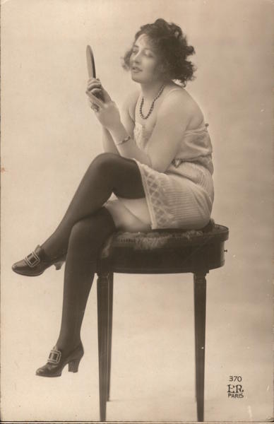 Woman looking in a mirror, Thigh-high stockings Risque & Nude