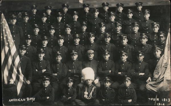 American Boys group photo, uniforms, one has large furred white hat. Tour 1913-1914 San Francisco California