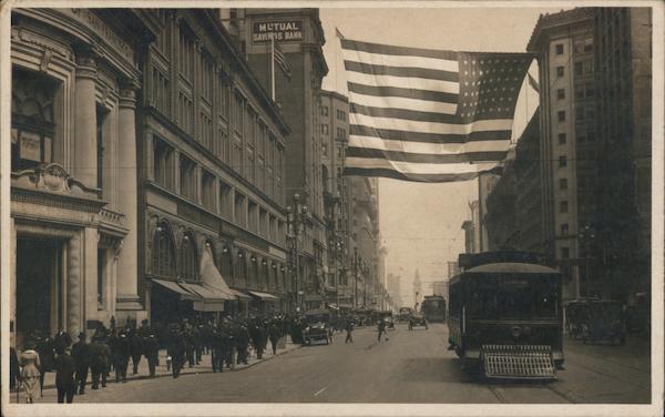 San Francisco downtown street scene with flag and streetcar, early 20th century California