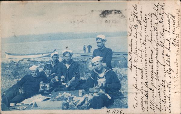 Group of sailors and dog picnicking near beach Navy
