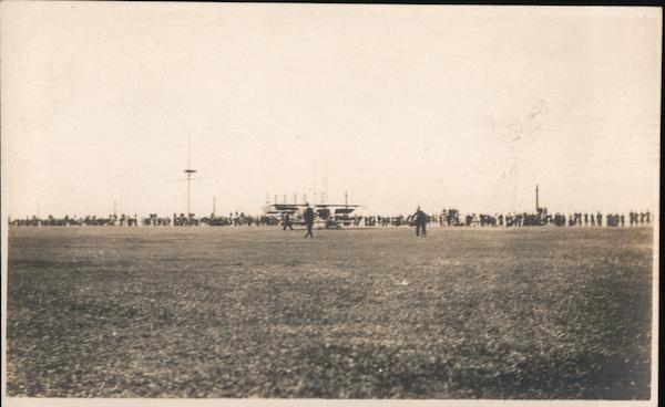 Crowd at airfield watching plane take off Aircraft