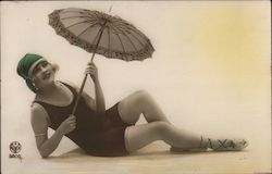 Pinup girl in swimsuit, parasol posing as if on beach Postcard