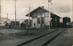 Winters train depot, horse drawn wagons, people waiting Postcard