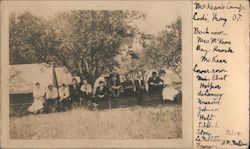 McKean's Camp, May. 07. Campers pose under tree, tents Postcard