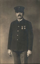 Studio photo of fireman with medals Postcard