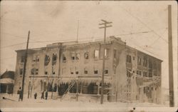 Apartment house, covered in ice in winter after fire Postcard