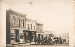 Horses and buggies waiting at a hitching rail Postcard