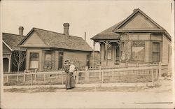 Woman and baby in front of a house, 1913 Postcard