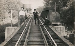 Three men standing on rail road bridge, water tower for train Laclede, MO Trains, Railroad Postcard Postcard Postcard
