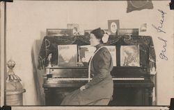 Woman sitting at a piano Postcard