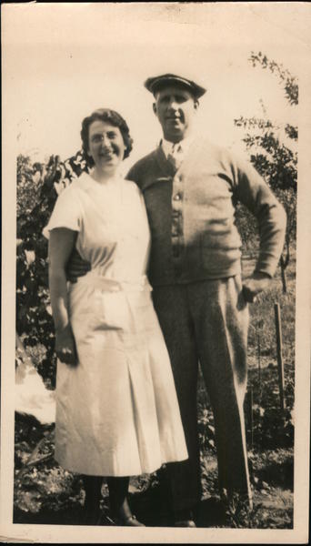 Photo of smiling couple in garden. 1934 Couples