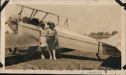 Two young ladies at Fresno Airport standing next to two-seater bi-plane Original Photograph