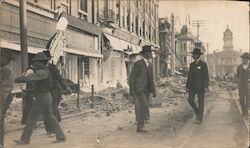 Ruins of street, Colins Bros. Druggist, men in streets, constable with badge, streetcar tracks Original Photograph