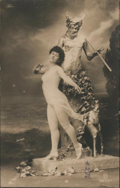Dancer posing with status of a faun Dancing