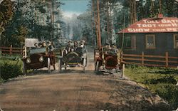 Toll Gate and old touring cars on a dirt road. Postcard