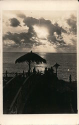 A view of a pier overlooking an ocean Postcard