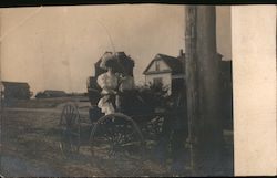 Couple in wedding attire sitting in a horse drawn carriage Postcard