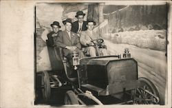 Four Men in a Car at a Photography Studio with a Wintery Backdrop Postcard