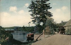 Old car passing by a Lake Postcard