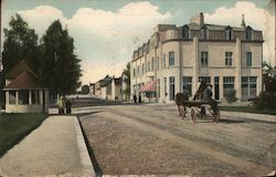 Street view with horse carriage and people on the sidewalk with large building in the background Postcard