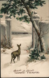 Velele Vanoce - A snowy scene with a tree and a deer Christmas Postcard Postcard Postcard