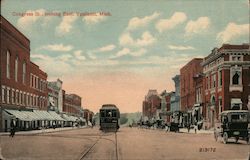 View of Congress Street, looking East. Trolley going down center of street. Postcard