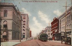 Looking west on Monroe Street, showing cars and trolleys, and the Register building Postcard