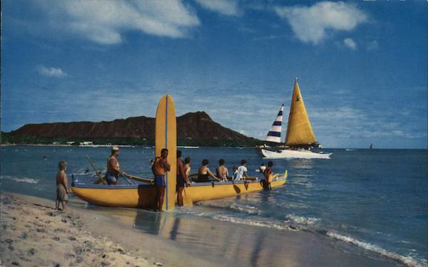 Fun at Waikiki beach - a traditional Hawaiian canoe is launched from the beach Honolulu