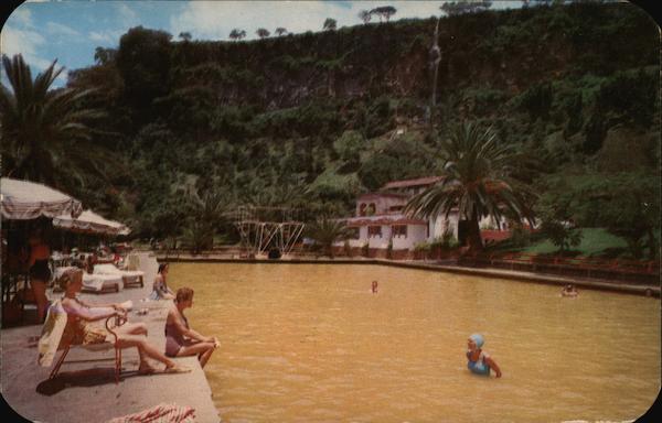 Swimming and relaxing at the yellow colored water pools at Balneario San Jose Purua hotel Michoacan Mexico