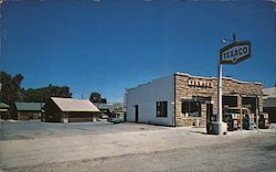 In the Heart of Town - A photo of a Texaco and a motel Postcard