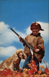 Toddler in Hunting Clothes, with a Rifle and Cocker Spaniel Postcard