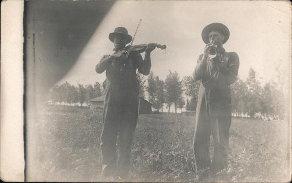 One Man Plays Fiddle, Another Man Plays Horn in Open Field Vining Minnesota
