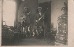 Two Men Pose with Ducks Strung Between Two Chairs Postcard