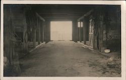 Interior view of empty stables Postcard