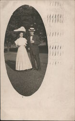 Man and woman wearing dressy clothes and fancy hats Postcard