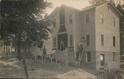 Carpenters constructing chimney on multi-story house Postcard