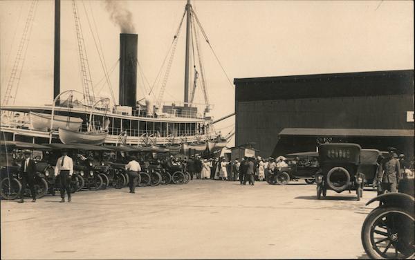 Early automobiles lined up at the pier with steamer San Francisco California