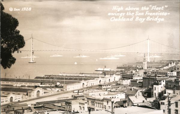 High Above the Fleet Swings the San Francisco-Oakland Bay Bridge California