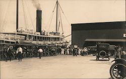 Early automobiles lined up at the pier with steamer Postcard