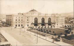 Auditorium with large garden lined grounds and wide empty streets Postcard