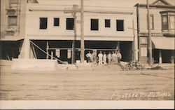 Construction crew in front of building Postcard