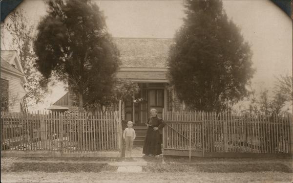 Transit Clerk Woman and Boy in front of a Residence Houston Texas