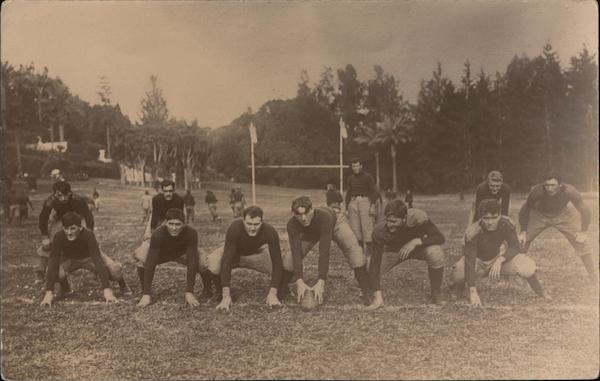 Football Team Kneeling on Field