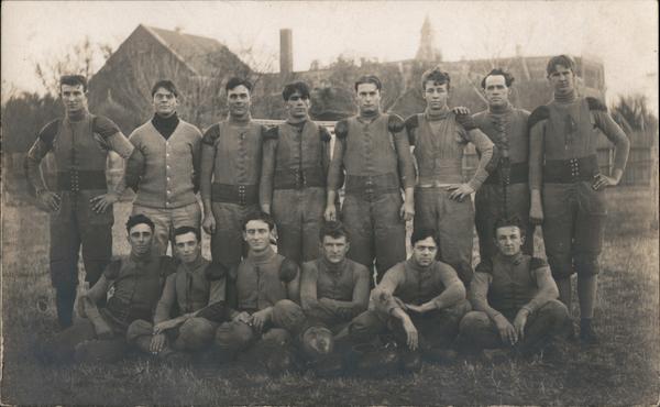 Football Team Seated in Field