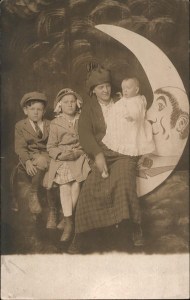 Woman, Boy, Girl and Infant on a Paper Moon Akron Ohio