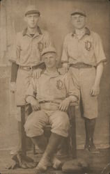 Three Baseball Players Pictured with Uniforms Displaying "LD" Postcard