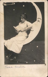 Young Woman Reading a Book on a Paper Moon Postcard