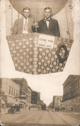 Two men posing in hot air balloon above city Studio Photo Postcard