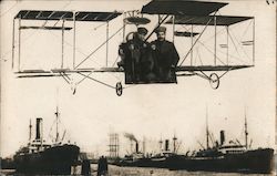 Two men flying over ocean liners Studio Photo Postcard