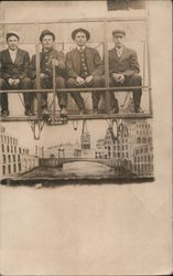 Four seated men posing in hot air balloon Studio Photo Postcard